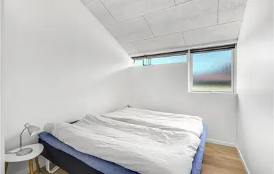 a white bedroom with a bed and a window at Stunning Home In Højslev With Kitchen in Højslev