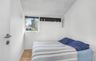 a bedroom with a bed and a window at Stunning Home In Højslev With Kitchen in Højslev