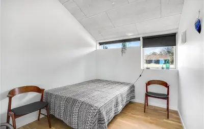 a bedroom with a bed and two chairs at Stunning Home In Højslev With Kitchen in Højslev