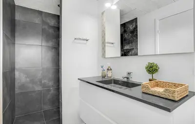 a bathroom with a sink and a mirror at Stunning Home In Højslev With Kitchen in Højslev