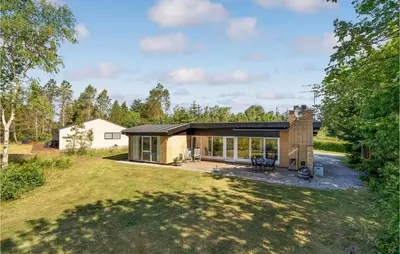 a small brick house with a large yard at Cozy Home In Vesløs With House Sea View in Øsløs