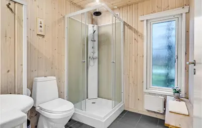 a bathroom with a shower and a toilet and a sink at Stunning Home In Hanstholm in Hanstholm