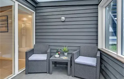 a patio with two chairs and a table with a drink at Stunning Home In Hanstholm in Hanstholm