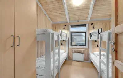 a room with four bunk beds in it at Cozy Home In Harboøre With Sauna in Harboør