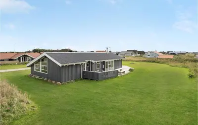 a house with a large yard with a house at Cozy Home In Harboøre With Sauna in Harboør