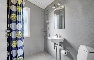 a bathroom with a sink and a shower curtain at Gorgeous Home In Vestervig With Kitchen in Vestervig