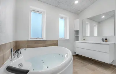 a white bathroom with a tub and a sink at Beautiful Home In Løgstrup With Kitchen in Løgstrup