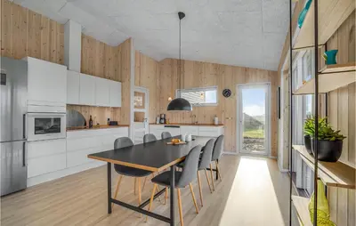 a kitchen with a dining room table and chairs at Beautiful Home In Løgstrup With Kitchen in Løgstrup