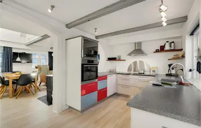 a kitchen with red and white cabinets and a table at Pet Friendly Home In Vils With Sauna in Vils