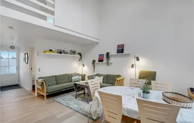 a living room with a table and a couch at Agger Havn Feriecenter in Vestervig