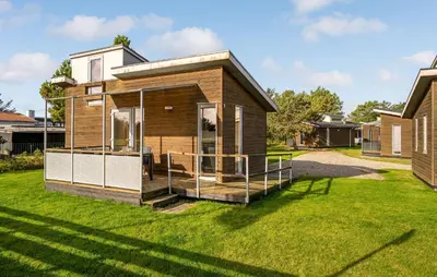 a tiny house with a deck in a yard at Cozy Home In Vestervig With Wifi in Vestervig