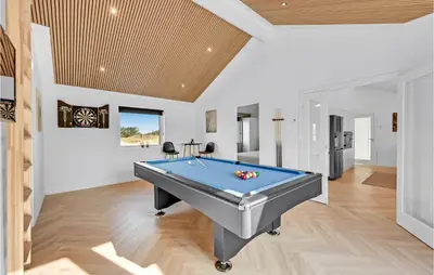 a pool table in a living room with a ceiling at Awesome Home In Harboøre With Kitchen in Harboør