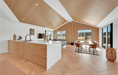 a kitchen and living room with a table and chairs at Awesome Home In Harboøre With Kitchen in Harboør