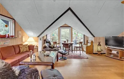 a living room with a couch and a table at Gorgeous Home In Roslev With Wifi in Roslev