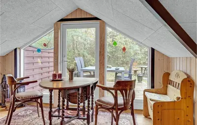 a room with a table and chairs and a window at Gorgeous Home In Roslev With Wifi in Roslev