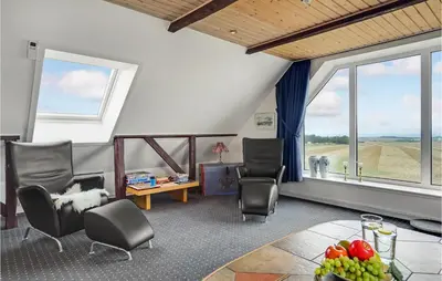 a living room with chairs and a table and windows at Gorgeous Home In Lemvig With Wifi in Lemvig