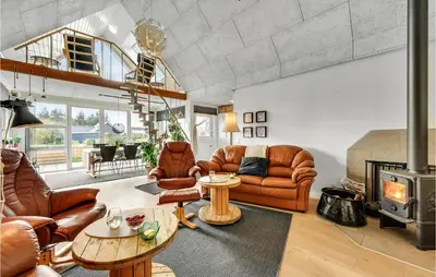 a living room with leather furniture and a fireplace at 3 Bedroom Beautiful Home In Vemb in Vemb
