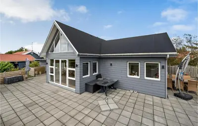 a small blue house with a large patio at 3 Bedroom Beautiful Home In Vemb in Vemb