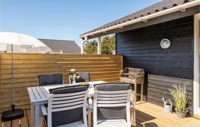 a patio with a table and chairs on a deck at Lovely Home In Thisted With Wifi in Thisted
