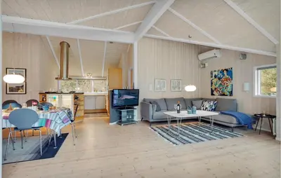 a living room with a couch and a table at Lovely Home In Bedsted Thy With Sauna in Bedsted Thy