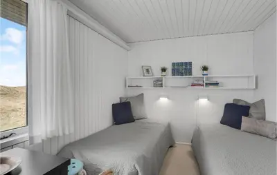 a white room with two beds and a window at Awesome Home In Pandrup With Wifi in Pandrup