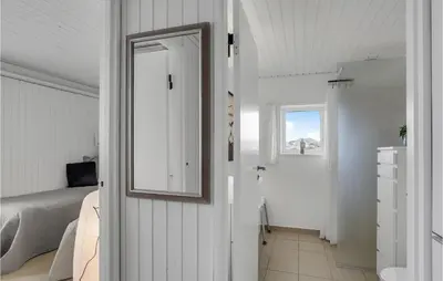 a bedroom with a bed and a mirror on the wall at Awesome Home In Pandrup With Wifi in Pandrup