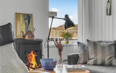 a living room with a fireplace and a couch at Awesome Home In Pandrup With Wifi in Pandrup