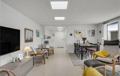 a living room with a couch and a table at Awesome Home In Pandrup With Wifi in Pandrup