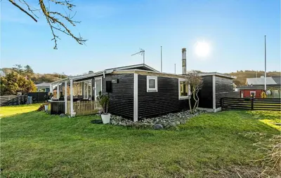 a house with a yard in front of it at 1 Bedroom Lovely Home In Løgstør in Løgstør