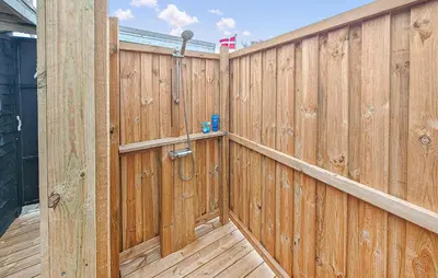 a wooden fence with a shower on top of it at 1 Bedroom Lovely Home In Løgstør in Løgstør