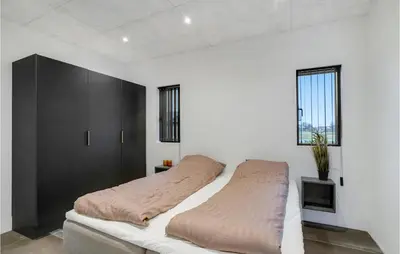 two beds in a bedroom with white walls and windows at Gorgeous Home In Thisted With Wifi in Thisted