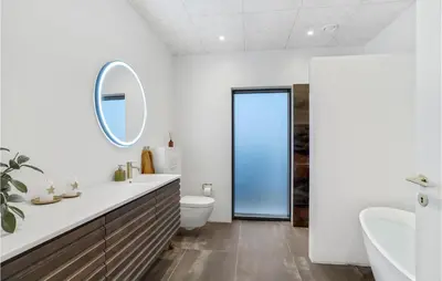 a bathroom with a sink and a toilet and a mirror at Gorgeous Home In Thisted With Wifi in Thisted