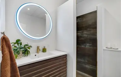a bathroom with a sink and a mirror at Gorgeous Home In Thisted With Wifi in Thisted