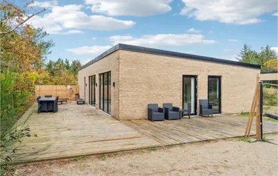 a small brick building with a wooden deck at Beautiful Home In Vestervig With Wifi in Vestervig