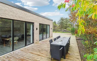 a wooden deck with a table and chairs on it at Beautiful Home In Vestervig With Wifi in Vestervig