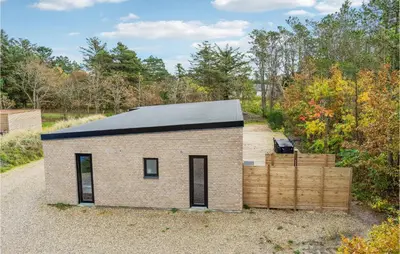 a small brick house with a black roof at Beautiful Home In Vestervig With Wifi in Vestervig