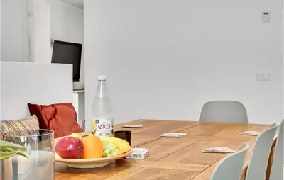 a table with a bowl of fruit and a bottle of milk at Beautiful Home In Vestervig With Wifi in Vestervig