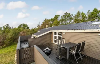 a deck with a table and chairs on a house at Amazing Home In Thisted With Sauna in Thisted
