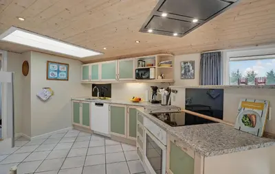 a kitchen with green and white cabinets and a counter at Amazing Home In Thisted With Sauna in Thisted