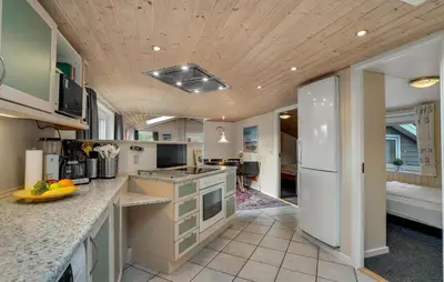 a kitchen with white appliances and a wooden ceiling at Amazing Home In Thisted With Sauna in Thisted