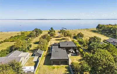 an aerial view of a house next to the water at Awesome Home In Thyholm With Wifi in Thyholm