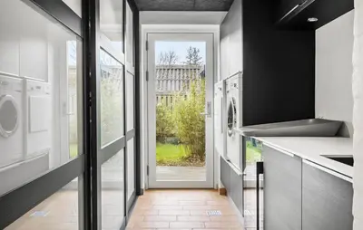 a hallway with a door leading to a laundry room at Awesome Home In Thyholm With Wifi in Thyholm