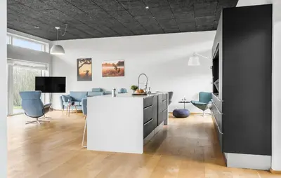 a kitchen with a white counter and blue chairs at Awesome Home In Thyholm With Wifi in Thyholm
