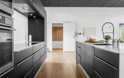 a kitchen with black cabinets and white walls at Awesome Home In Thyholm With Wifi in Thyholm