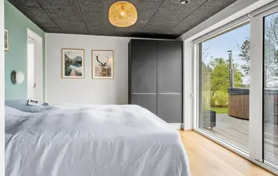 a bedroom with a large bed and a large window at Awesome Home In Thyholm With Wifi in Thyholm