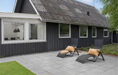 two chairs on a patio in front of a house at Stunning Home In Vemb With Wifi in Vemb