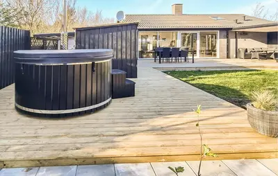 a backyard with a wooden deck and a house at 3 Bedroom Lovely Home In Hurup Thy in Sønder Ydby