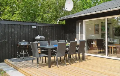 a patio with a table and chairs and a grill at 3 Bedroom Lovely Home In Hurup Thy in Sønder Ydby