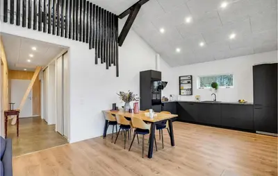 a dining room and kitchen with a table and chairs at Gorgeous Home In Thyholm With Wifi in Thyholm
