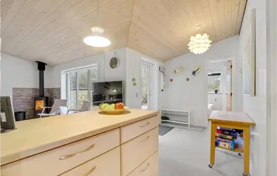 a kitchen with a wooden counter and a living room at 3 Bedroom Lovely Home In Hurup Thy in Sønder Ydby